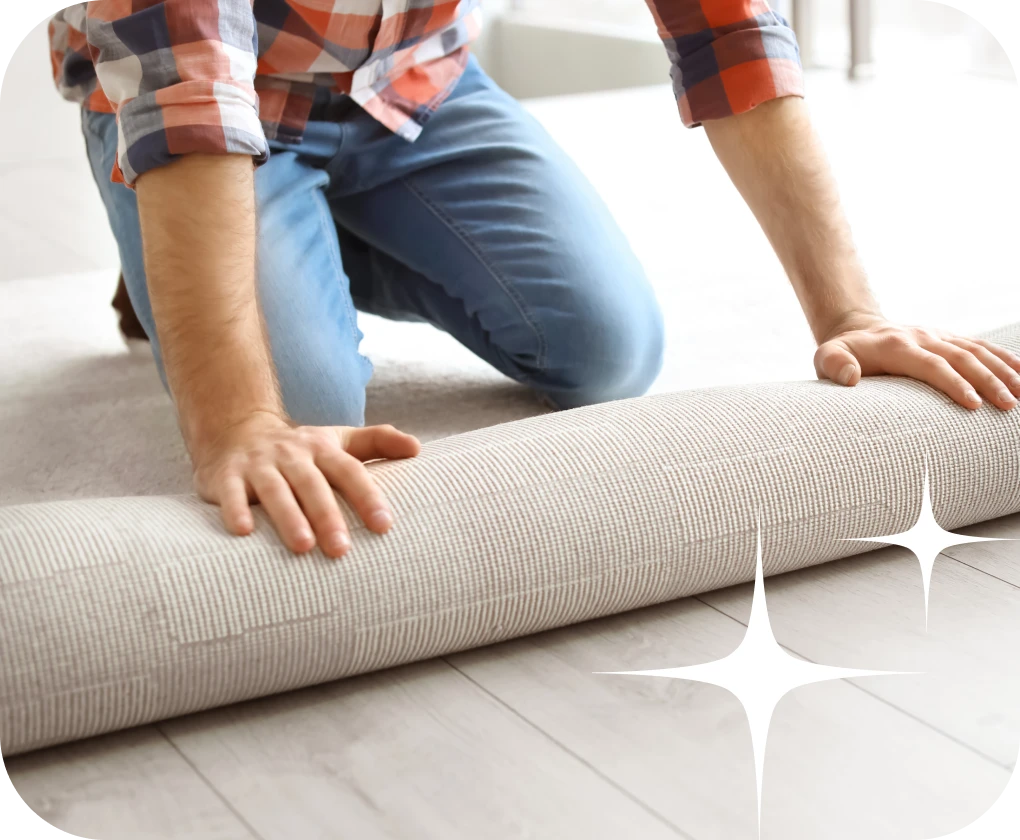 Close up of worker rolling out and installing carpet | Lloyd's Carpets & Draperies