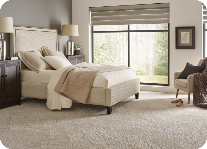 Carpet in warm colored bedroom | Lloyd's Carpets & Draperies