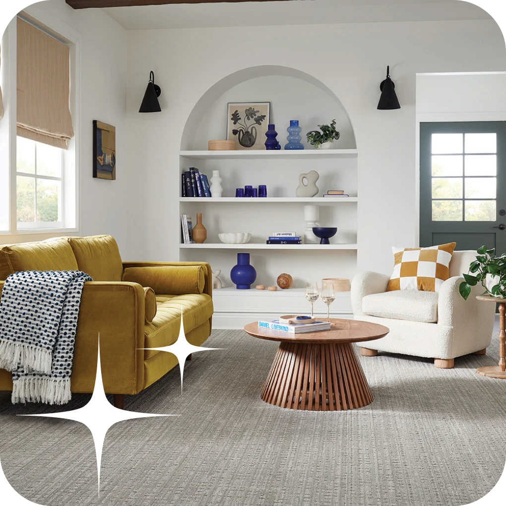 Patterned in modern living space with yellow couch and colorful decoration | Lloyd's Carpets & Draperies