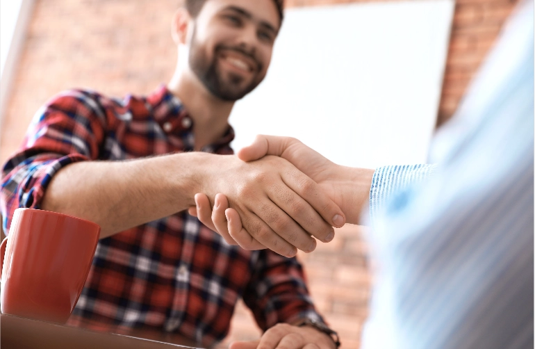 Customer shaking hands with worker of approval of financing | Lloyd's Carpets & Draperies