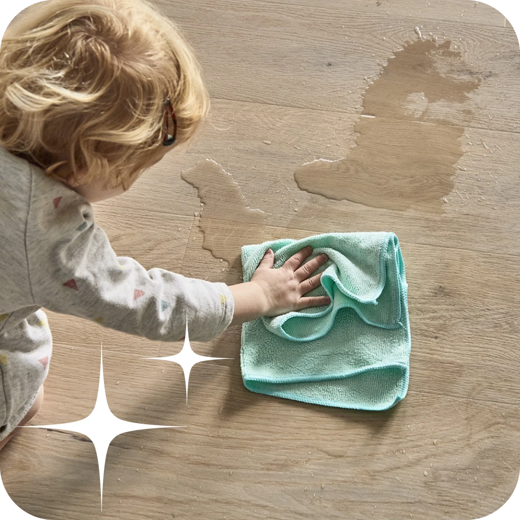 Childing wiping up spill on luxury vinyl flooring | Lloyd's Carpets & Draperies
