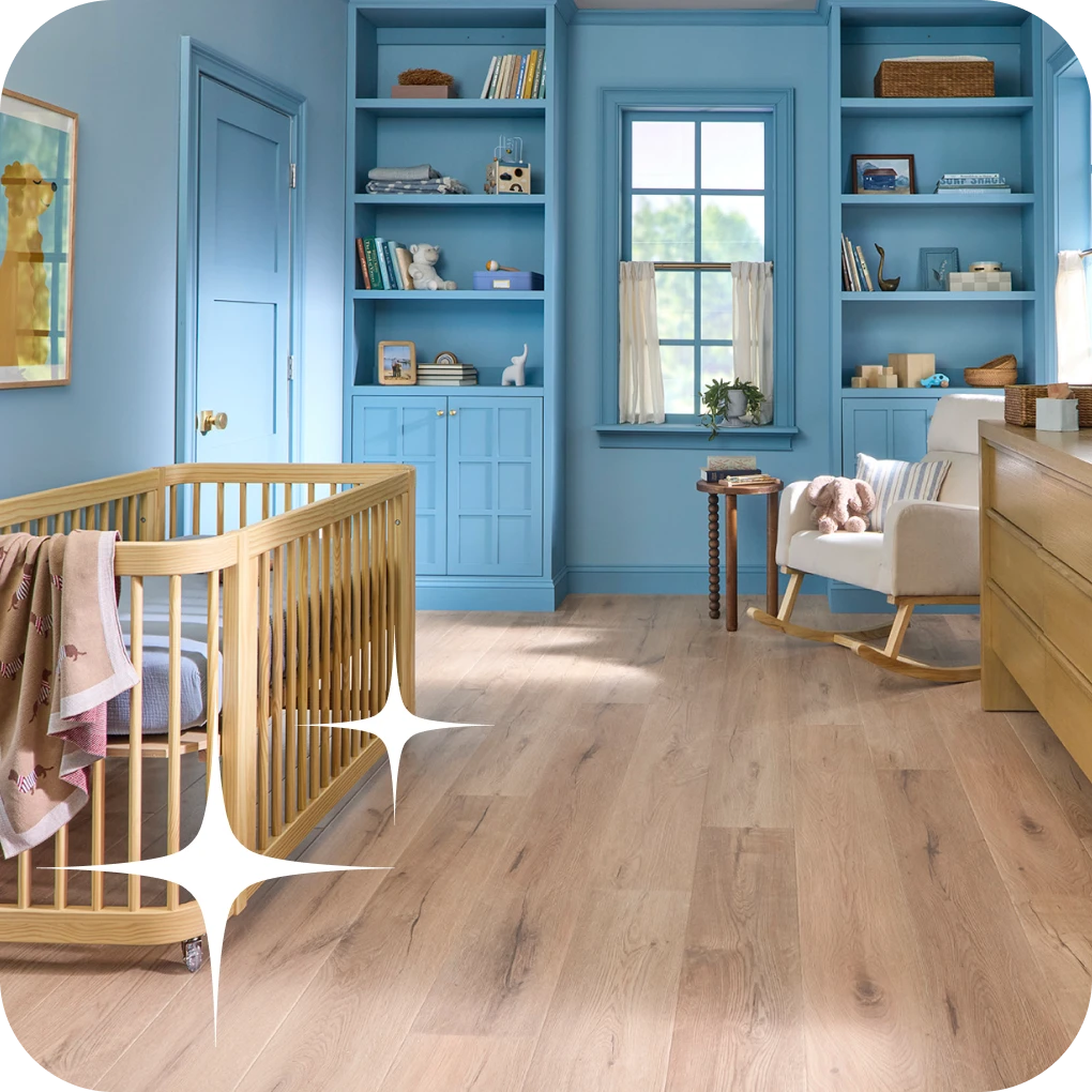 Luxury Vinyl flooring in nursery room with blue walls and cabinets | Lloyd's Carpets & Draperies